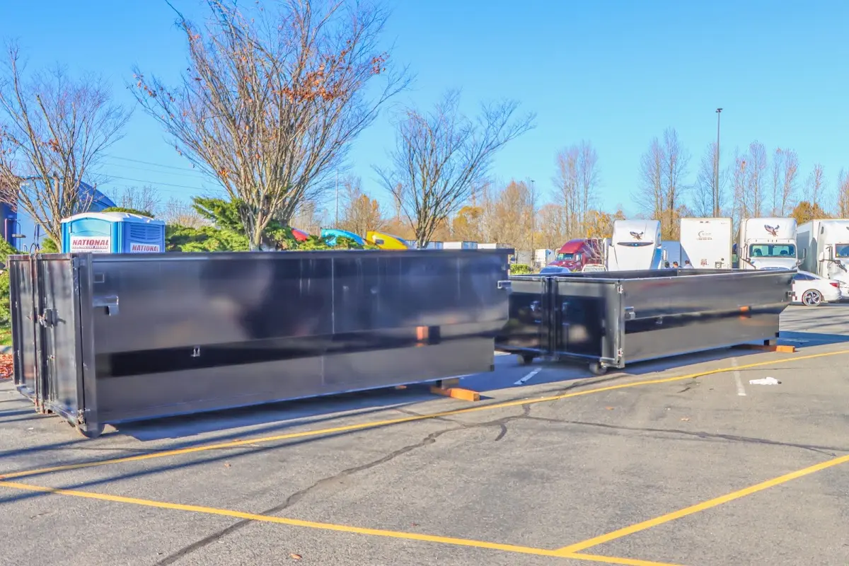 Professional dumpster rental service with roll-off container on residential driveway in North Lakes